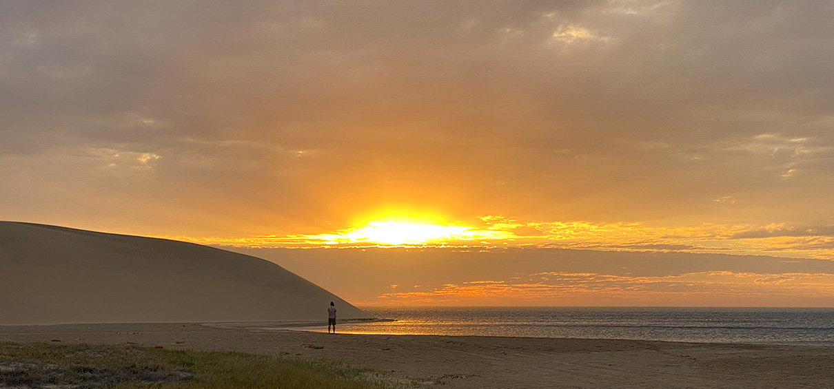 view of Sandwich Harbour with sunset in the background